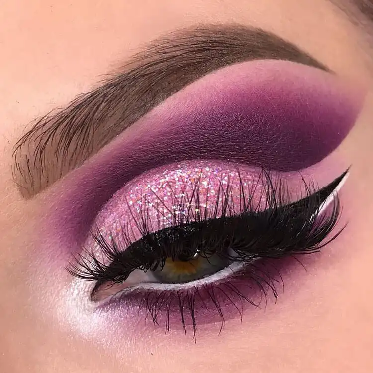 Enchanting purple glitter eye makeup, offering an alternative to traditional holiday colors.