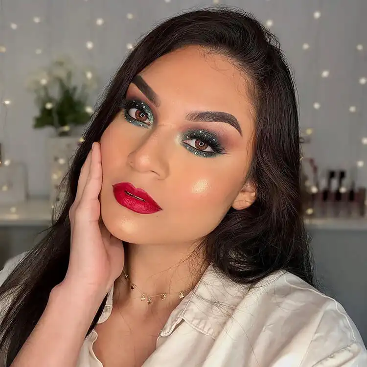 Close-up of a face showcasing glowing highlighter on cheekbones, nose, and cupid's bow for a dewy look.