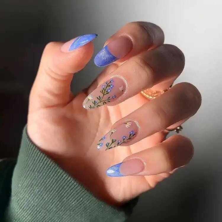 Beautiful hand-painted blue flower nail design by Nia Ho, a wonderful blue nail design that is classic and artistic.