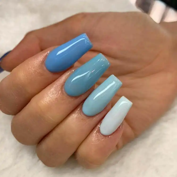 Ombre effect nails showcasing five different shades of blue, a wonderful blue nail design that is bold and classic.