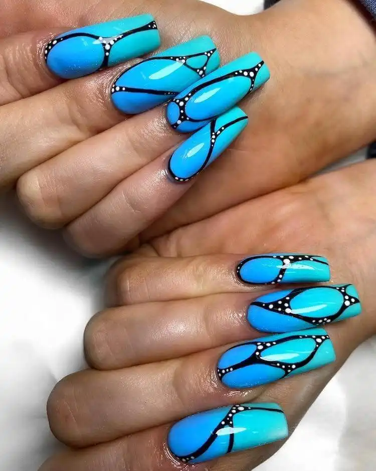 Elegant blue swirl design combined with a French tip, a wonderful blue nail design that is classic and bold.