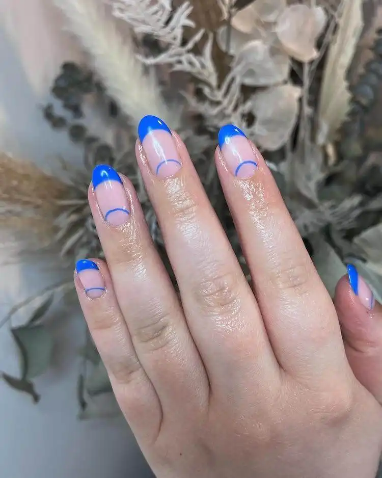Fun blue nails with mixed patterns and doodles, including cheetah print, a wonderful blue nail design that is bold and classic.