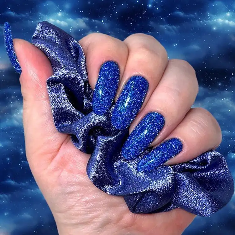 Long ballerina nails inspired by clouds in the sky, featuring soft blues and whites, a wonderful blue nail design that is classic and bold.
