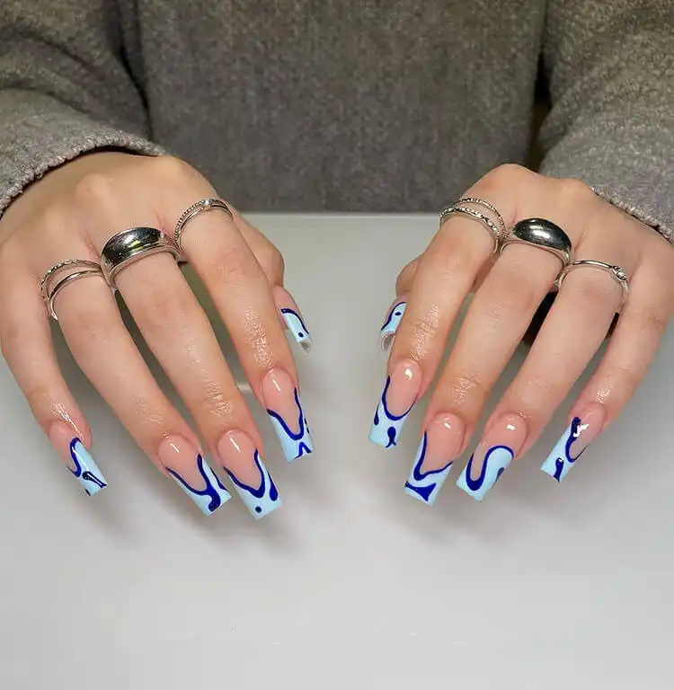 Sparkling blue nails with glossy royal blue polish and glitter, a wonderful blue nail design that is bold and classic.