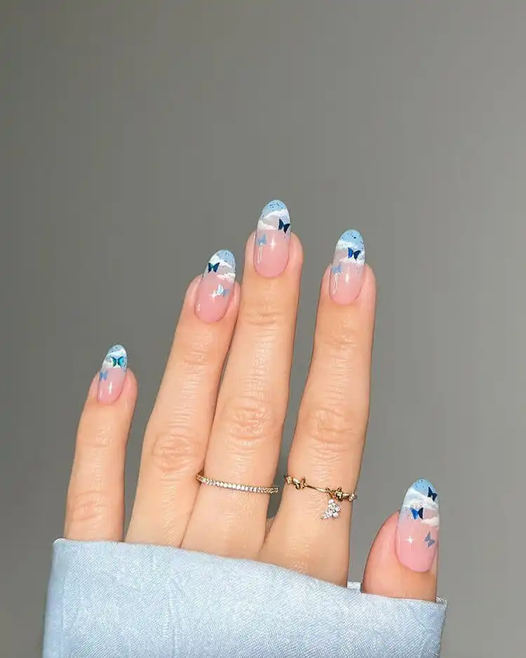 Modern blue French tip nails, offering a colorful twist on a classic, a wonderful blue nail design that is bold and classic.