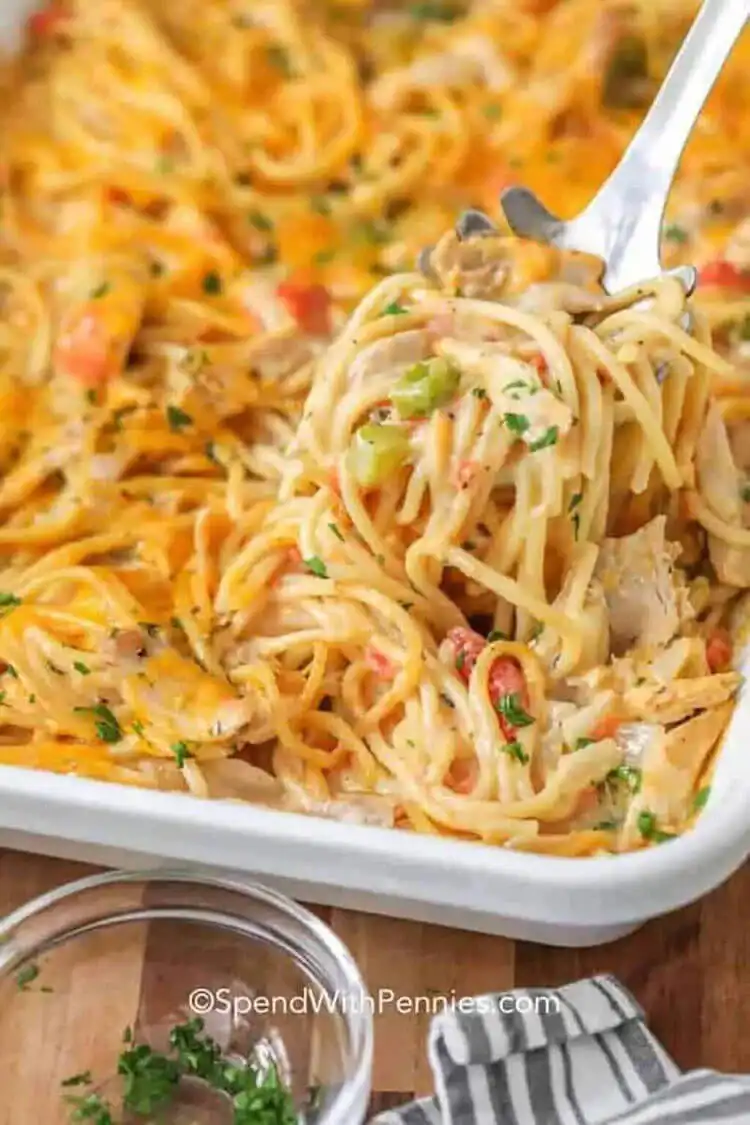 A bubbling homemade chicken spaghetti casserole dish, rich with cheese, chicken, and pasta.