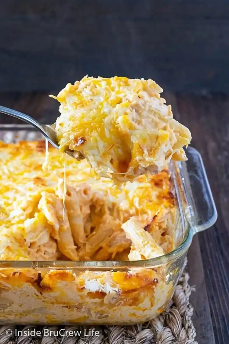 A serving of buffalo chicken pasta bake in a bowl, showing pasta coated in a zesty sauce with chicken and melted cheese.