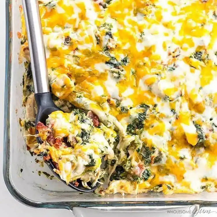 A bubbling chicken ranch casserole in a baking dish, with melted cheese and a creamy texture.