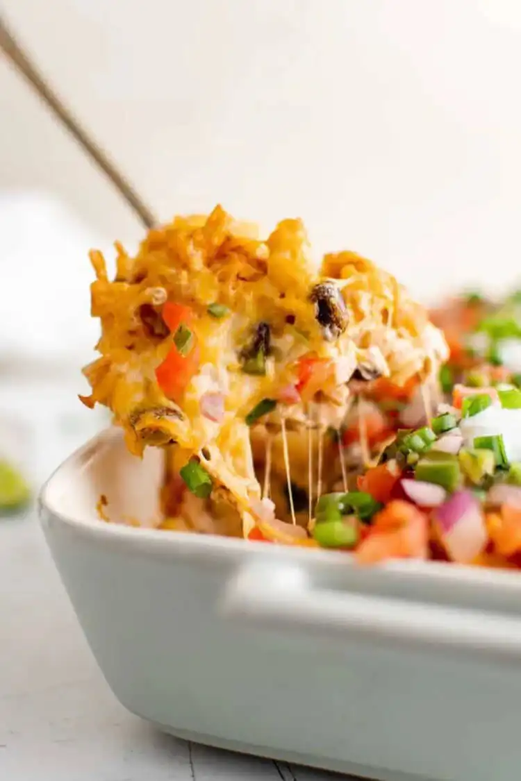 A colorful fiesta chicken casserole, loaded with chicken, pasta, black beans, corn, and melted cheese.